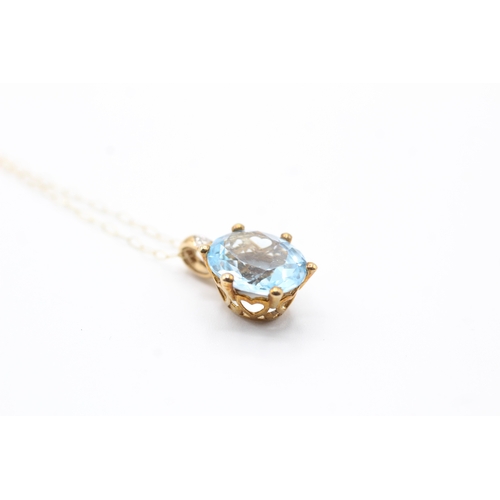 92 - 9ct gold oval cut blue gemstone & diamond pendant necklace (2.4g)