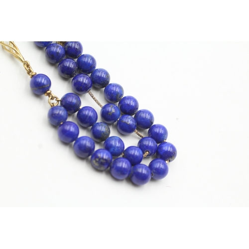 109 - 18ct gold lapis lazuli twist necklace (33.7g)