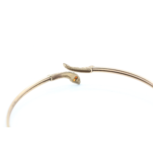 12 - 9ct gold garnet eye snake bangle (5g)