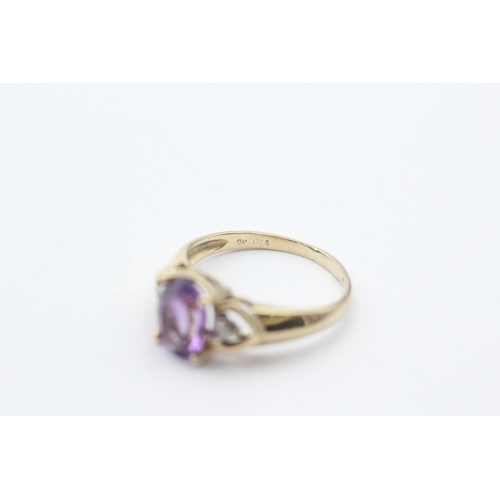 150 - 9ct gold oval purple gemstone and diamond ring (2.3g) Size O