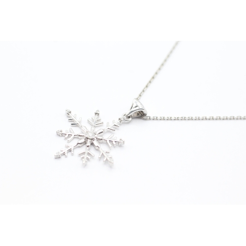 153 - 9ct gold diamond snowflake pendant on chain (3.8g)