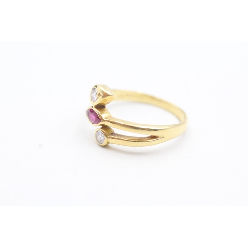 21 - 18ct gold diamond and ruby set bypass ring (3.9g) Size O 1/2