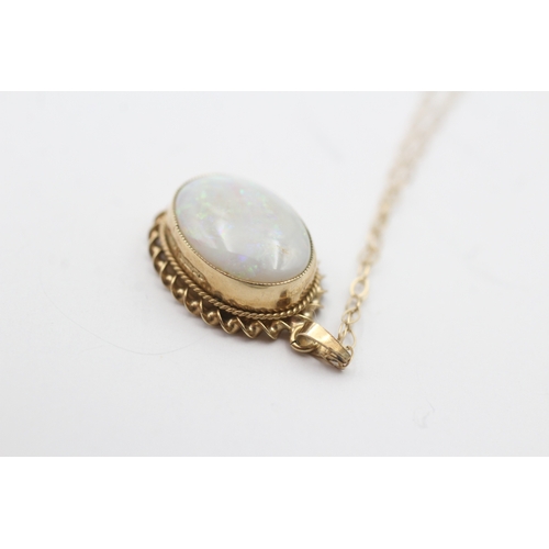 228 - 9ct gold opal cabochon pendant on chain (1.9g)