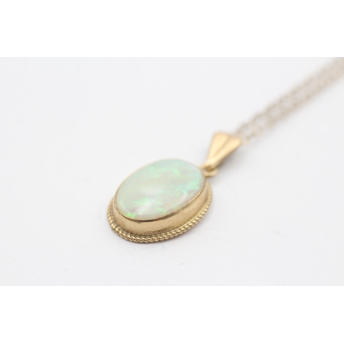 235 - 9ct gold opal cabochon pendant on chain (2.6g)