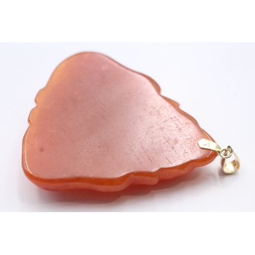 250 - 14ct gold red carved jade pendant (17.9g)