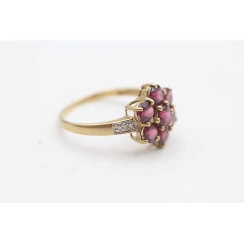 51 - 9ct gold ring with red gemstone flower cluster and diamond shoulders (2g) Size P