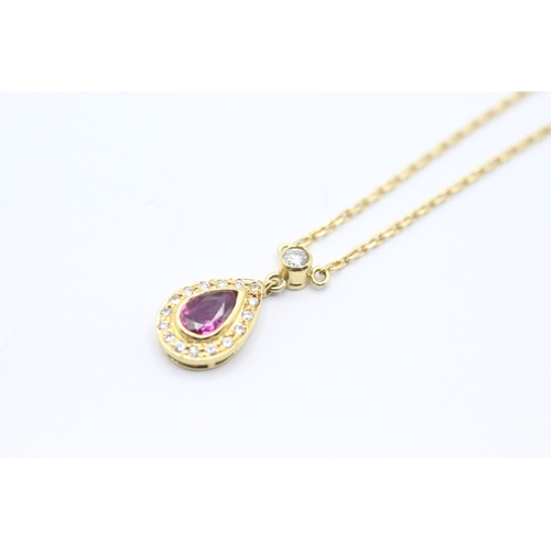 74 - 18ct gold ruby and diamond halo teardrop pendant on chain (3.9g)