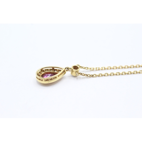 74 - 18ct gold ruby and diamond halo teardrop pendant on chain (3.9g)