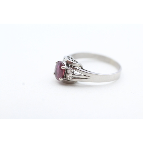 122 - 14ct white gold ruby and diamond framed ring (2.6g) Size N