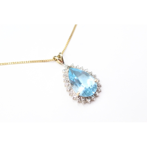 169 - 9ct gold pear cut blue gemstone and diamond pendant on chain (3.7g)