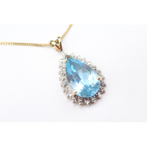 169 - 9ct gold pear cut blue gemstone and diamond pendant on chain (3.7g)