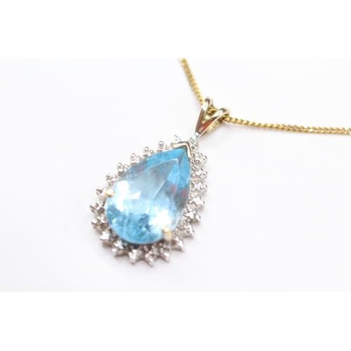 169 - 9ct gold pear cut blue gemstone and diamond pendant on chain (3.7g)