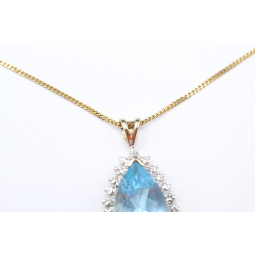 169 - 9ct gold pear cut blue gemstone and diamond pendant on chain (3.7g)