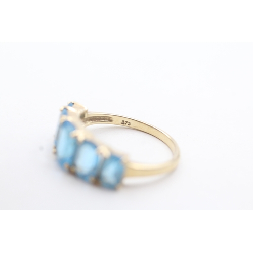 182 - 9ct gold with five blue gemstone set ring (3.1g)