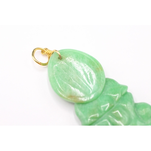 187 - 14ct gold carved jade pendant with gold bail (6.6g)