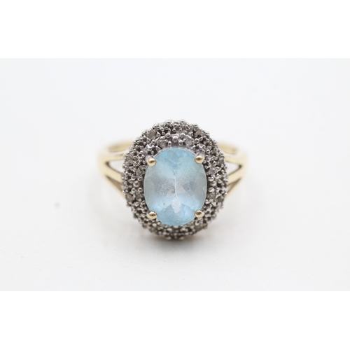 199 - 9ct gold ring with central blue gemstone surrounded by diamonds (3.9g) Size Q