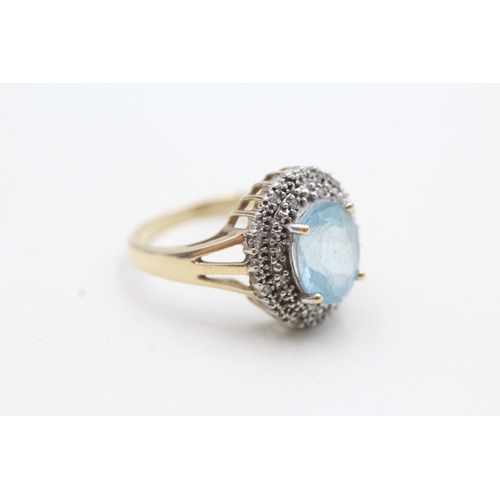 199 - 9ct gold ring with central blue gemstone surrounded by diamonds (3.9g) Size Q