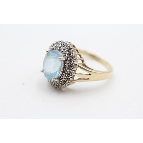 199 - 9ct gold ring with central blue gemstone surrounded by diamonds (3.9g) Size Q