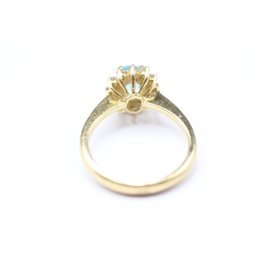 211 - 18ct gold topaz and diamond halo set ring (4.3g) Size L 1/2