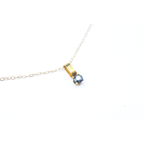 227 - 9ct gold and sapphire pendant on chain (0.5g)