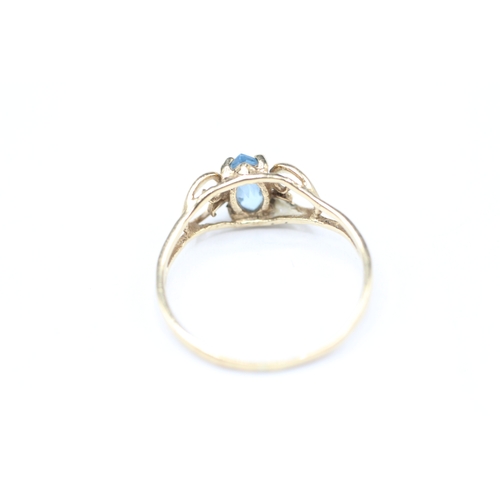 242 - 9ct gold blue gemstone set ring (1.2g) Size M