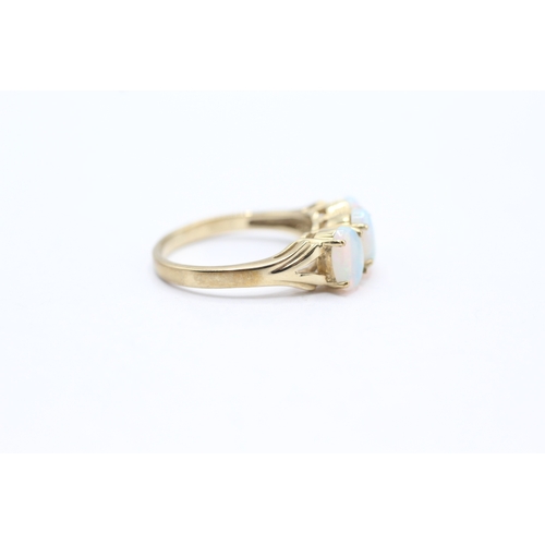 28 - 9ct gold and three stone opal ring (2.9g) Size N