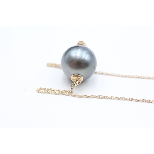 38 - 9ct gold cultured pearl drop pendant on chain (5.6g)