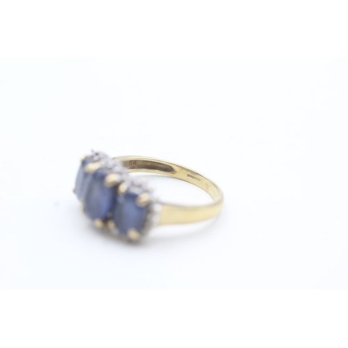 56 - 9ct gold ring with three blue gemstones surrounded by diamonds (3g) Size L 1/2