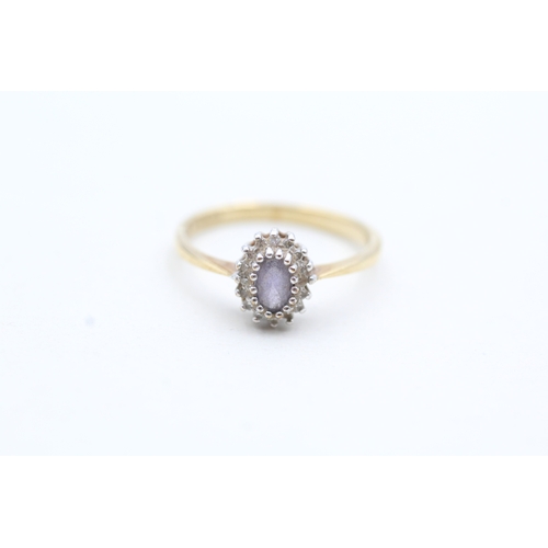 67 - 9ct gold purple gemstone and diamond halo set ring (1.5g) Size K