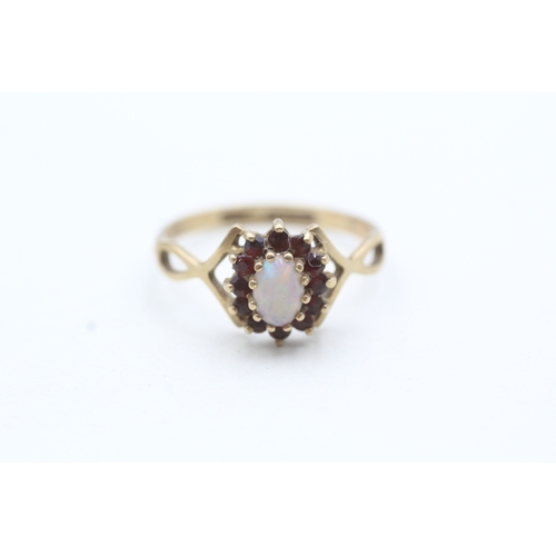 86 - 9ct gold opal and red gemstone ring (1.8g) Size P