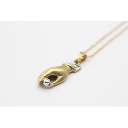 91 - 18ct gold hand diamond pendant on chain (3.2g)