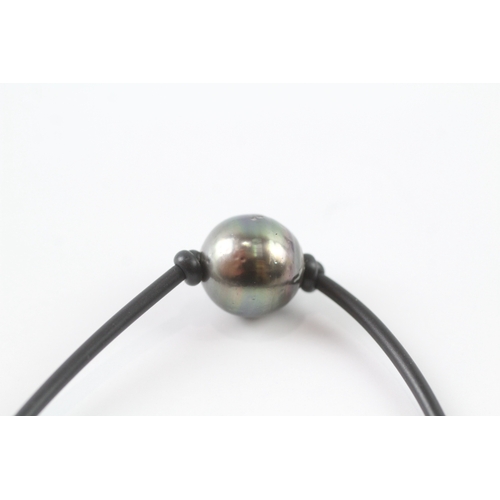 10 - 18ct gold cultured pearl on a black cord bracelet (4g)