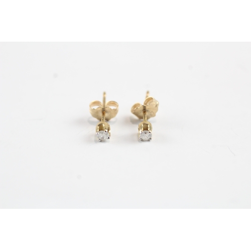 216 - 10ct gold single diamond stud earrings