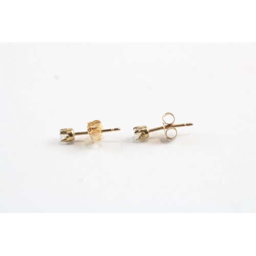 216 - 10ct gold single diamond stud earrings