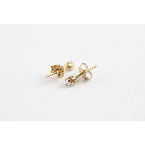 216 - 10ct gold single diamond stud earrings