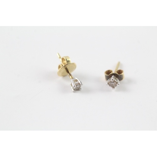 201 - 18ct gold single diamond stud earrings