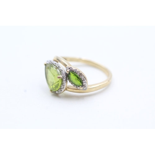 203 - 9ct gold diamond and green gemstone bypass ring (2.7g) Size L 1/2