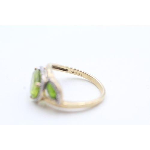 203 - 9ct gold diamond and green gemstone bypass ring (2.7g) Size L 1/2