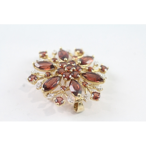 214 - 9ct gold garnet and diamond floral brooch