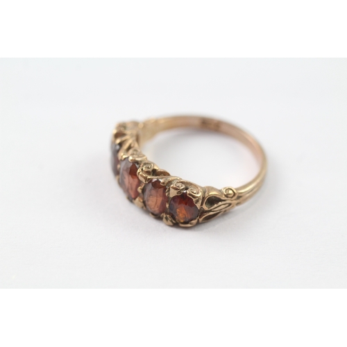 225 - 9ct gold red gemstone five stone ring (3.8g) Size P