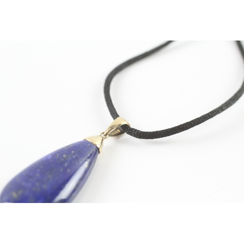 72 - 9ct gold lapis lazuli pendant necklace on a black cord (11.4g)