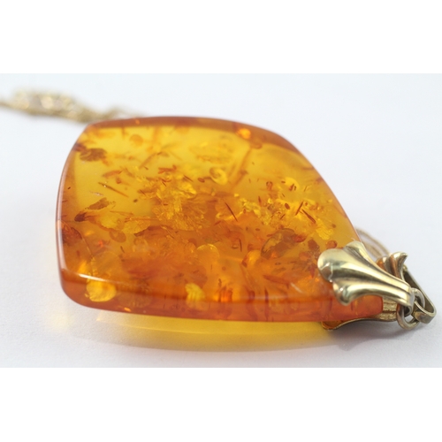 131 - 8ct gold amber pendant on 9ct chain (9.1g)