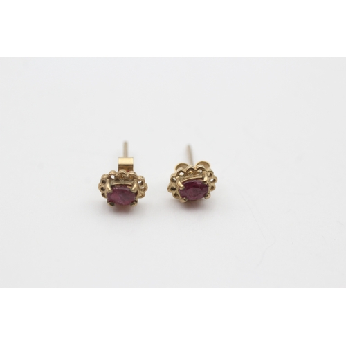 225 - 9ct gold oval cut ruby stud earrings (0.8g)