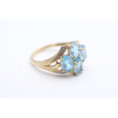 240 - 9ct gold diamond and topaz four stone ring (3.5g) Size P