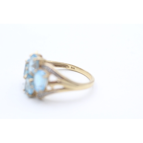 240 - 9ct gold diamond and topaz four stone ring (3.5g) Size P