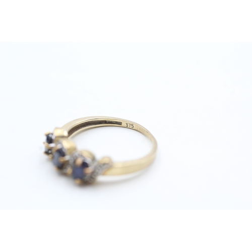 247 - 9ct gold diamond and sapphire trilogy ring (2g) Size M