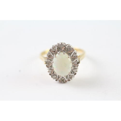 26 - 18ct gold opal and diamond halo dress ring (4.7g) Size M 1/2