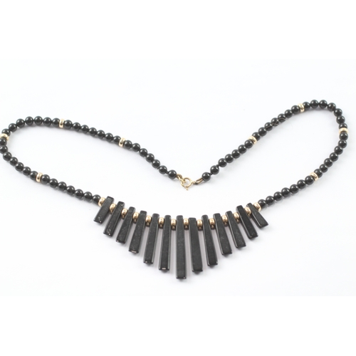 37 - 9ct gold black gemstone necklace (14.4g)