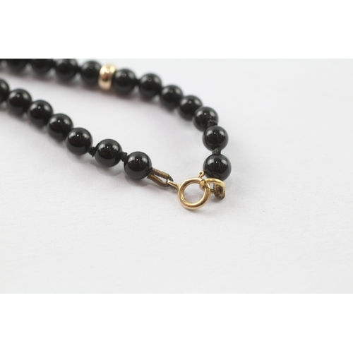 37 - 9ct gold black gemstone necklace (14.4g)