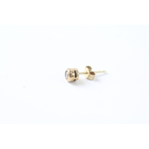 47 - 9ct gold bezel set diamond stud earrings (1g)